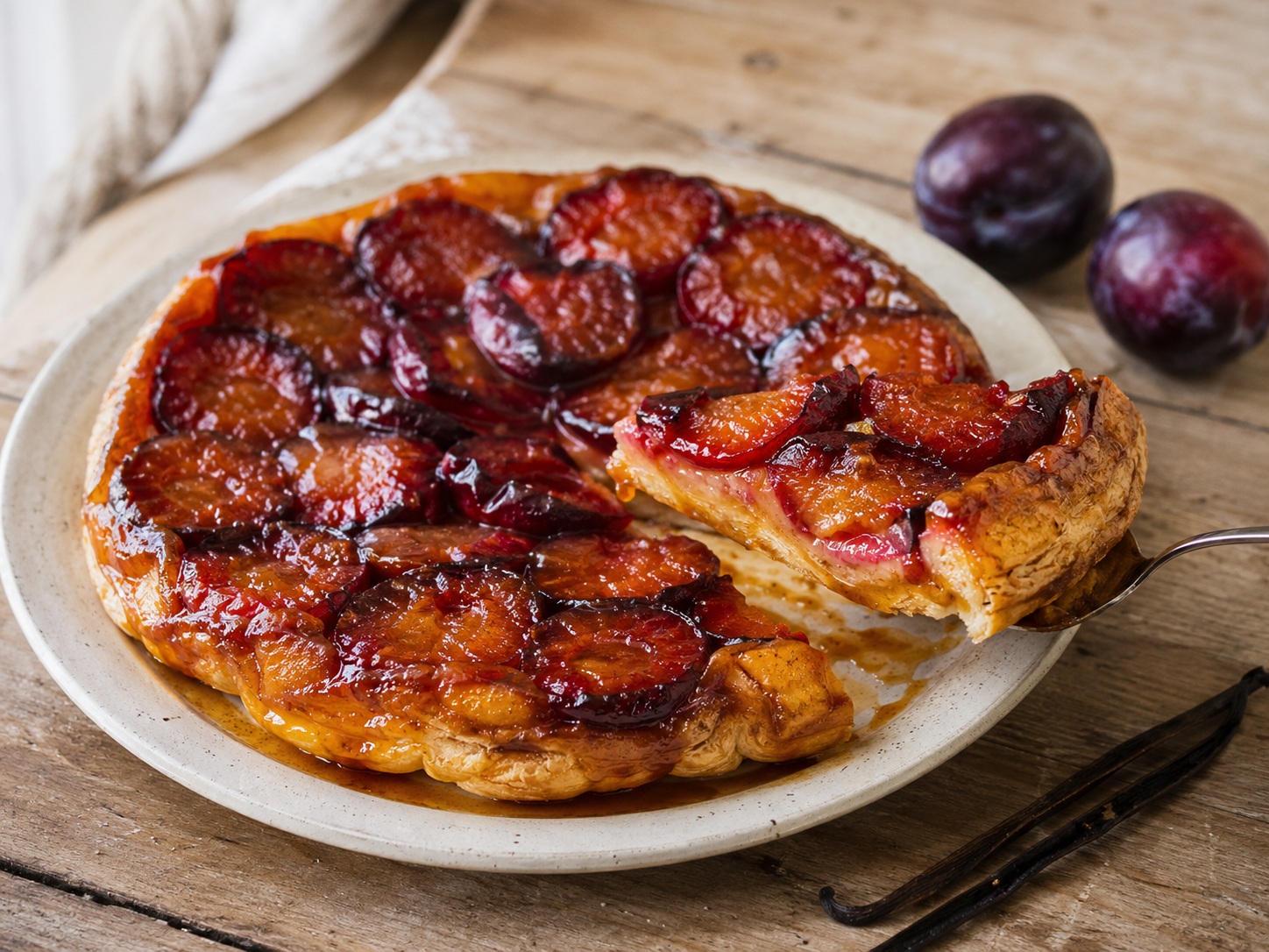 Victoria plum and vanilla tarte Tatin, golden and caramelised, fresh from the oven